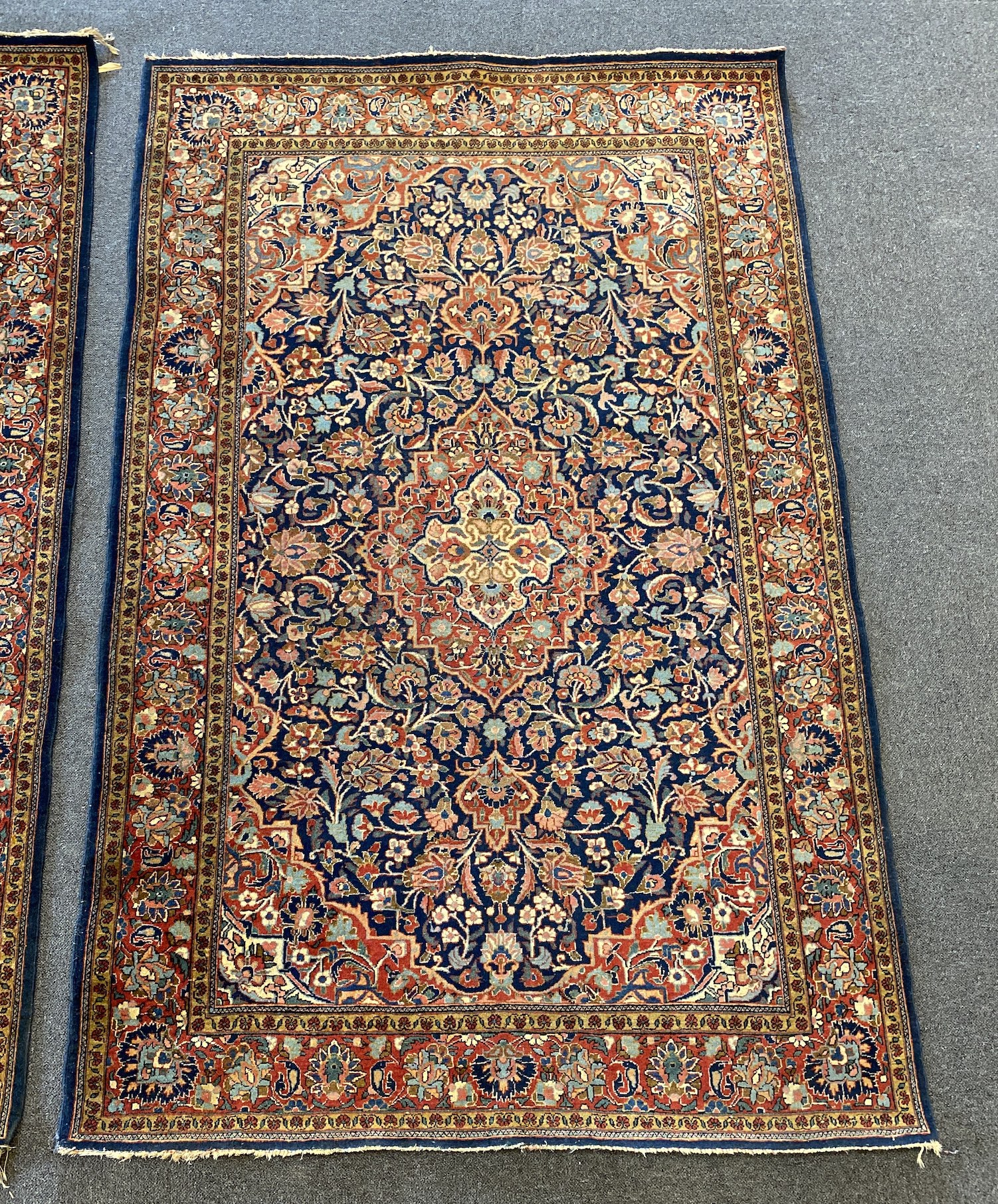 A pair of Kashan blue ground rugs, 213 x 139cm